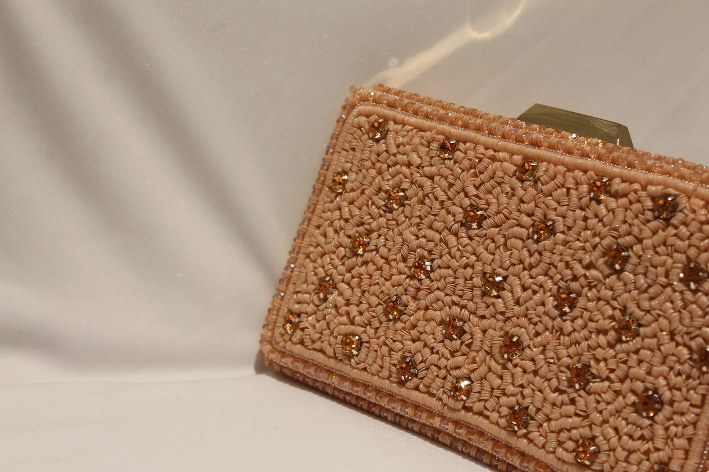 Rose gold clutch with handle and sling
