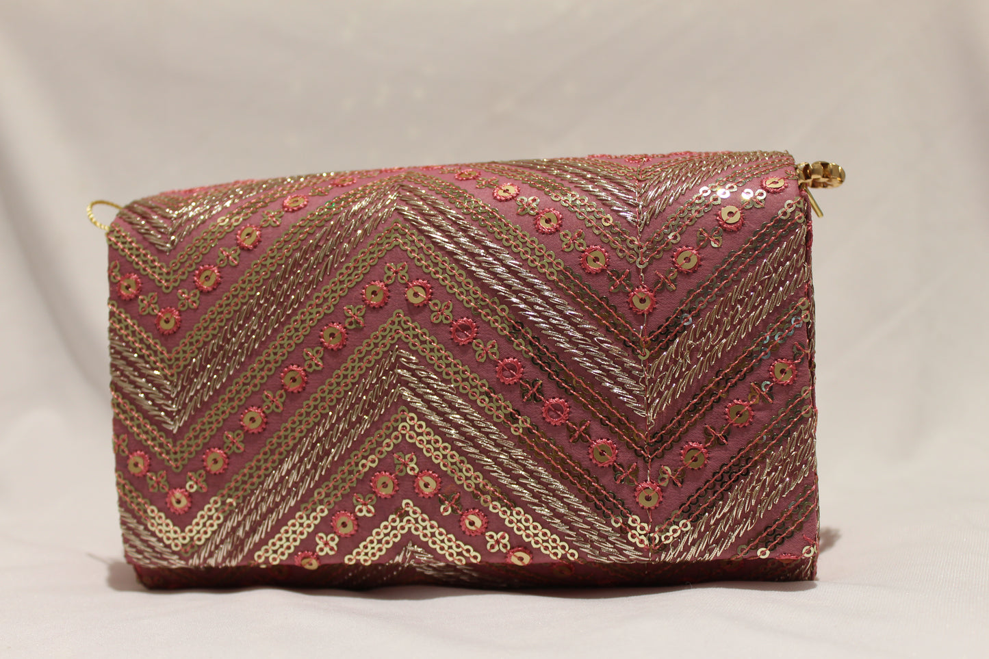 Pink hand clutch with sling