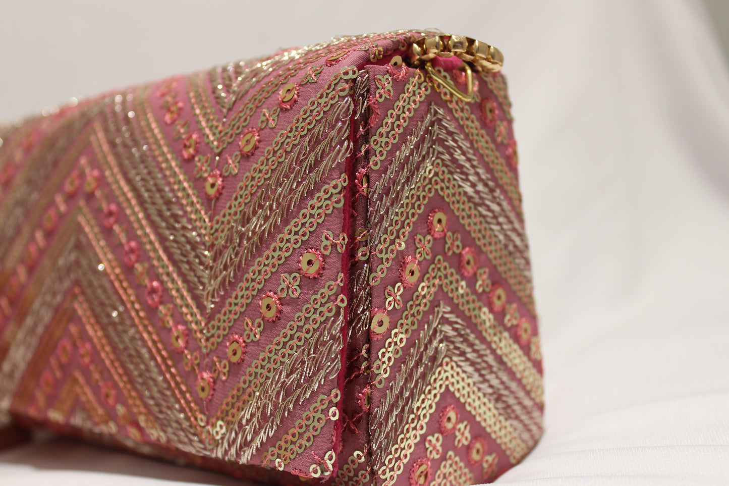 Pink hand clutch with sling