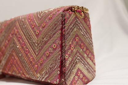 Pink hand clutch with sling