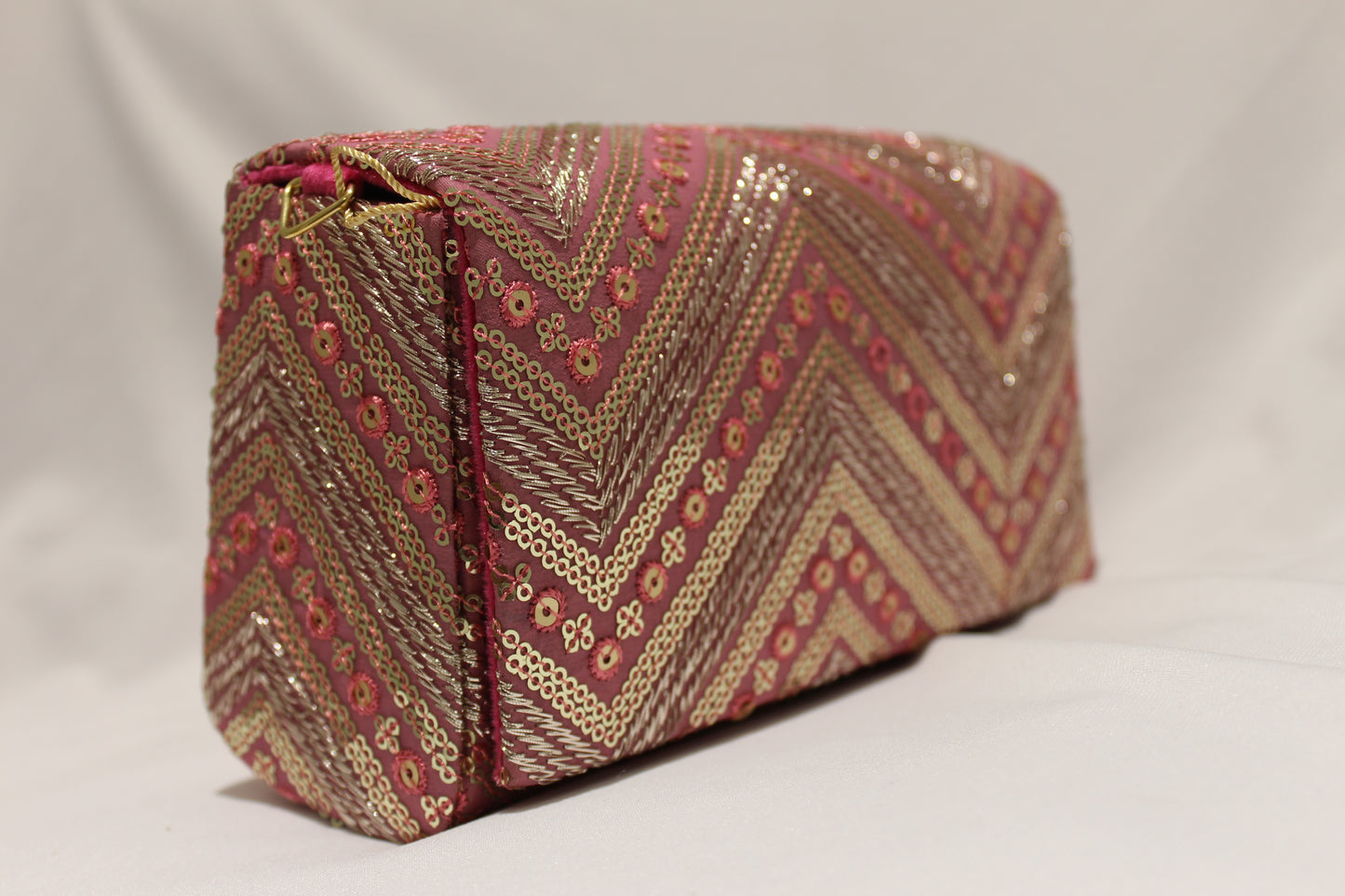 Pink hand clutch with sling