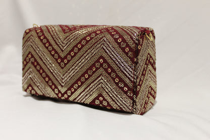 Maroon hand clutch with sling